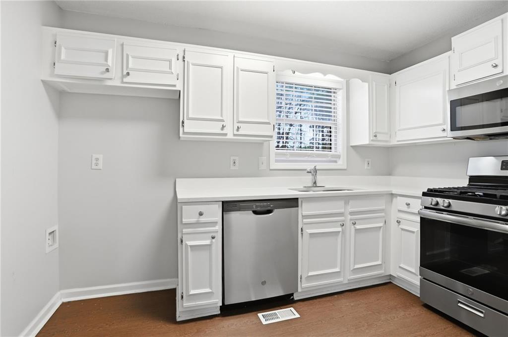 113 Hampton Drive Dallas, GA 30132 - Photo 11 of 30 a kitchen with white cabinets stainless steel appliances and sink