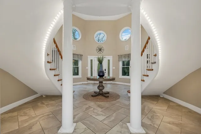 a living room with wooden floor and a table