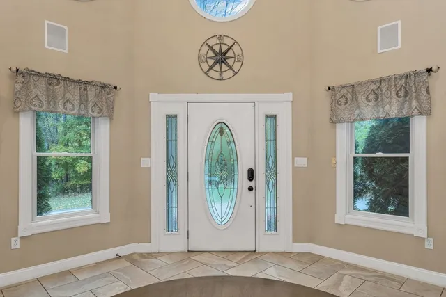 a bedroom with a large bed and a window