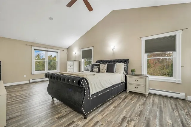 a bedroom with a large bed and a flat tv screen