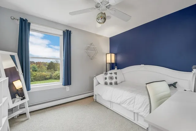 a view of a livingroom with furniture and a window