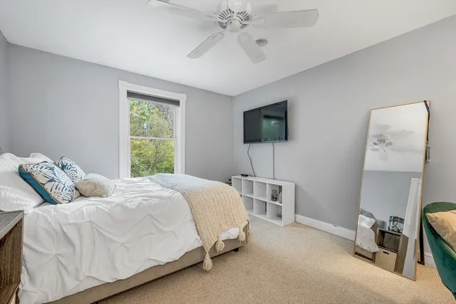 a bedroom with a bed a table and chair