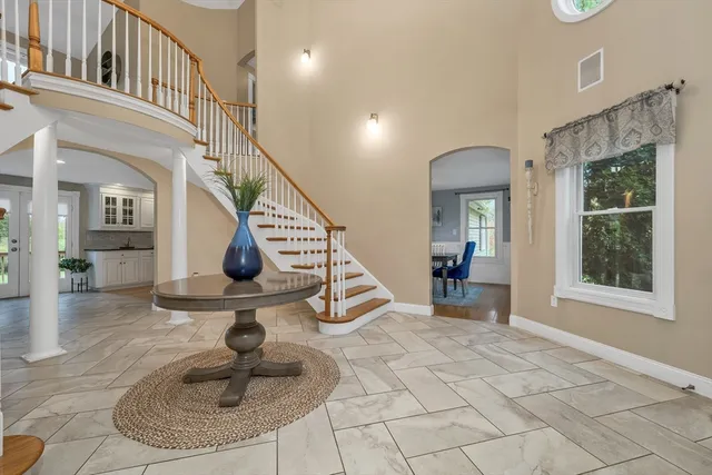 a living room with furniture and a open kitchen view