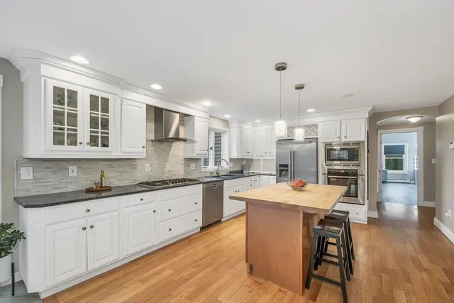 a large white kitchen with a large window