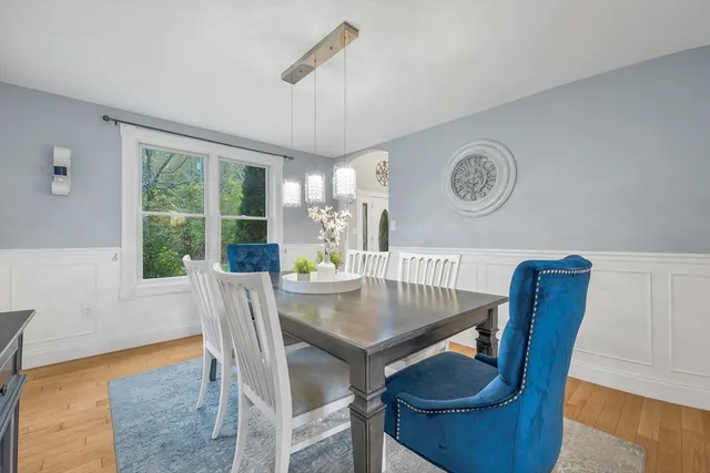 a dining room with furniture a window and wooden floor