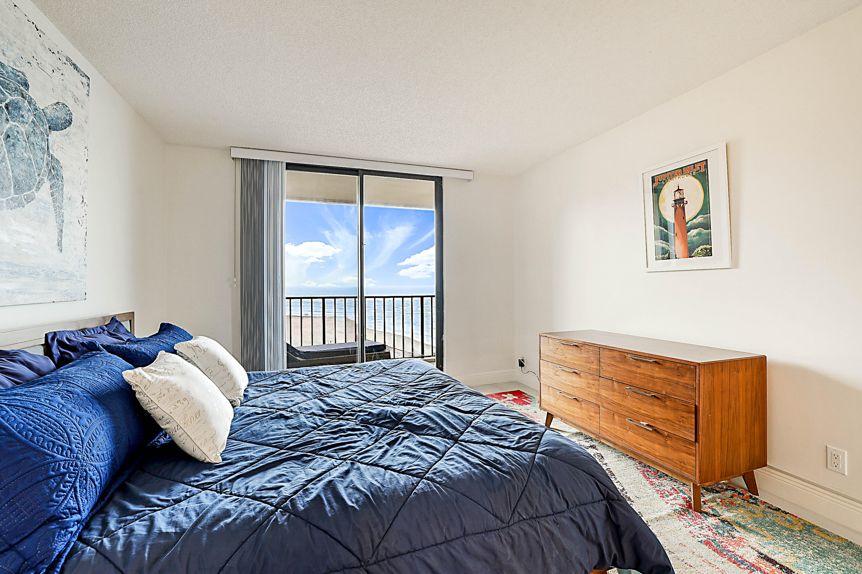 100 Ocean Trail Way, Unit 1003 Jupiter, FL 33477 - Photo 16 of 33 a bedroom with a bed and a window