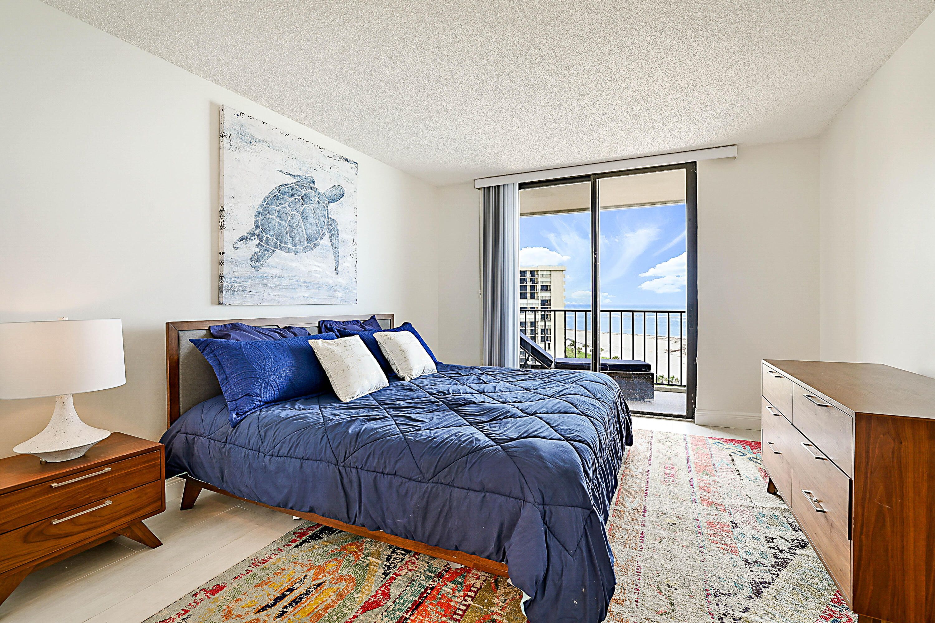 100 Ocean Trail Way, Unit 1003 Jupiter, FL 33477 - Photo 17 of 33 a bedroom with a large bed and a window