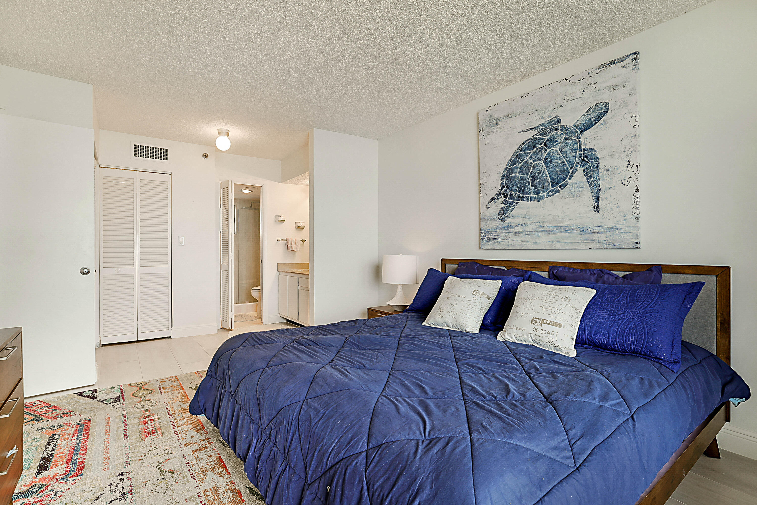 100 Ocean Trail Way, Unit 1003 Jupiter, FL 33477 - Photo 18 of 33 a large bed sitting in a bedroom and a table