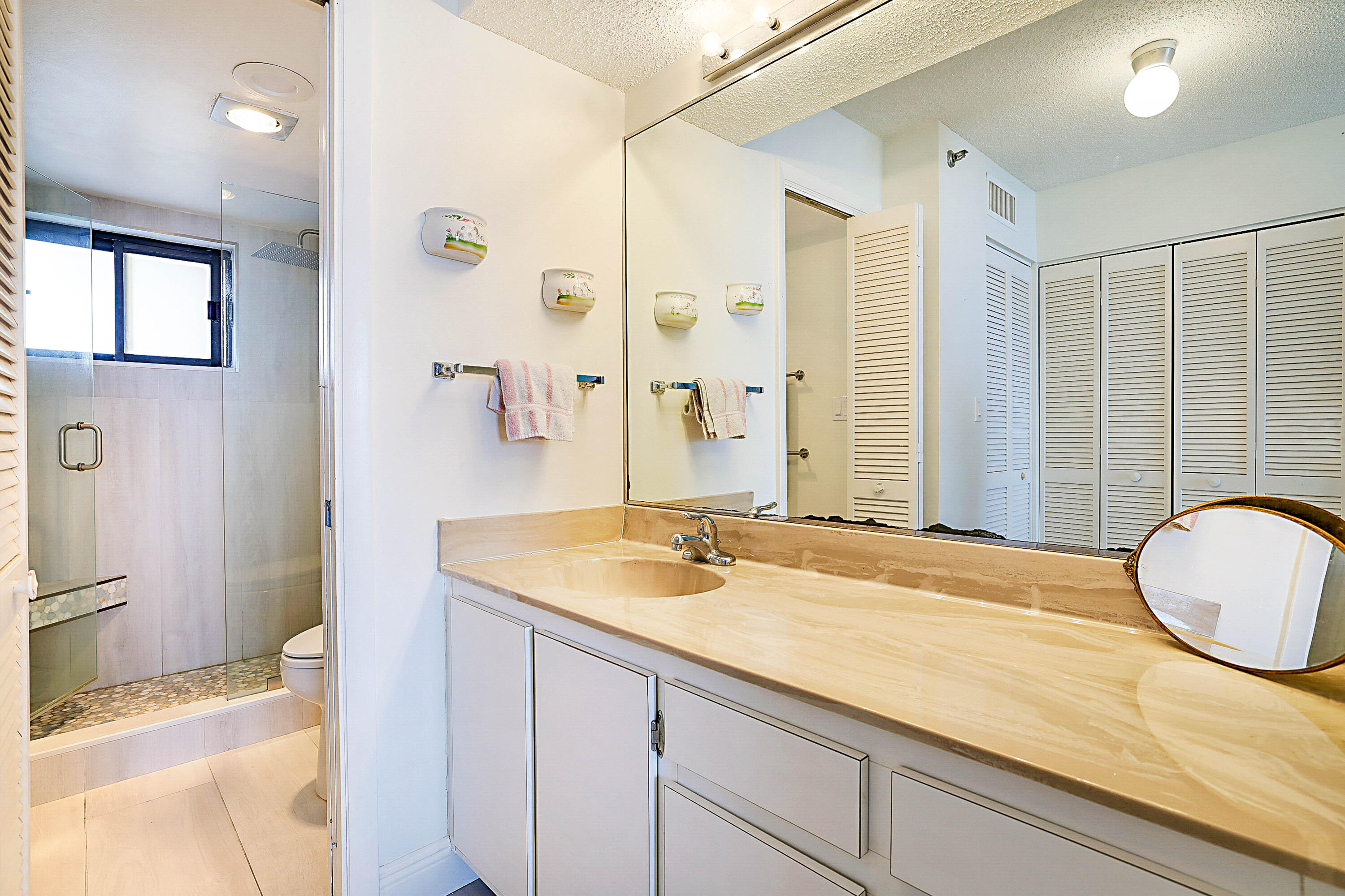 100 Ocean Trail Way, Unit 1003 Jupiter, FL 33477 - Photo 20 of 33 a bathroom with a granite countertop sink and a mirror