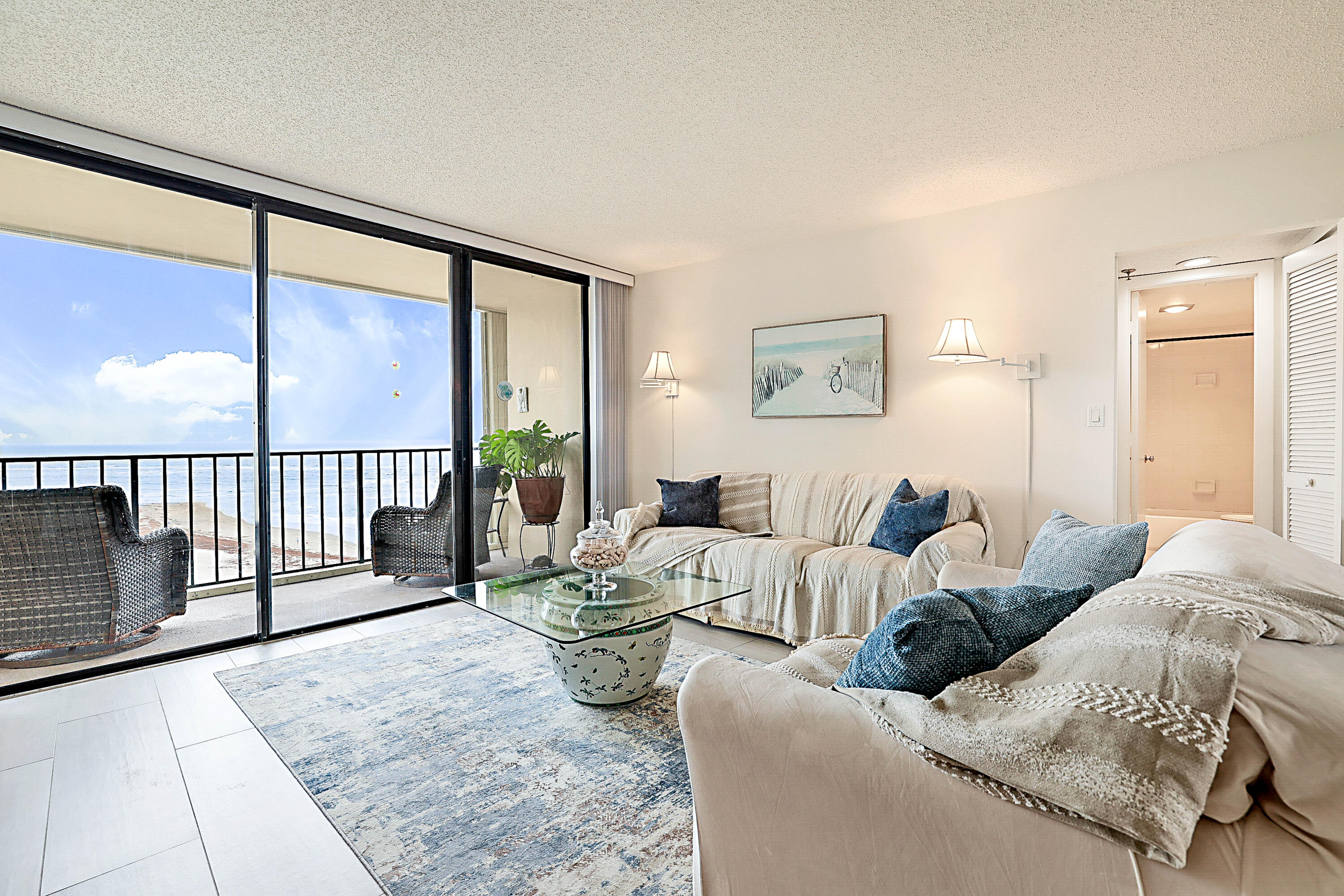 100 Ocean Trail Way, Unit 1003 Jupiter, FL 33477 - Photo 2 of 33 a living room with furniture and a large window