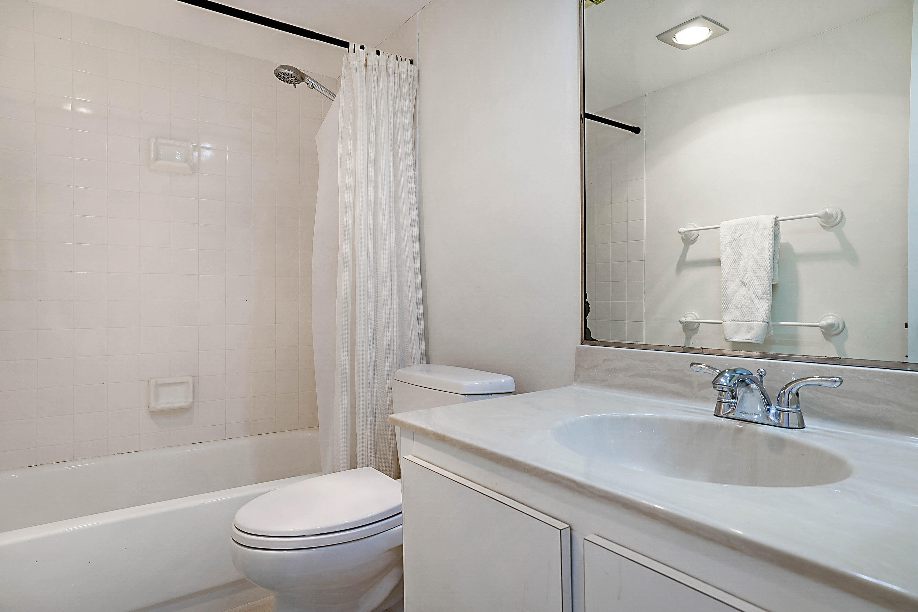 100 Ocean Trail Way, Unit 1003 Jupiter, FL 33477 - Photo 22 of 33 a bathroom with a granite countertop sink toilet and shower