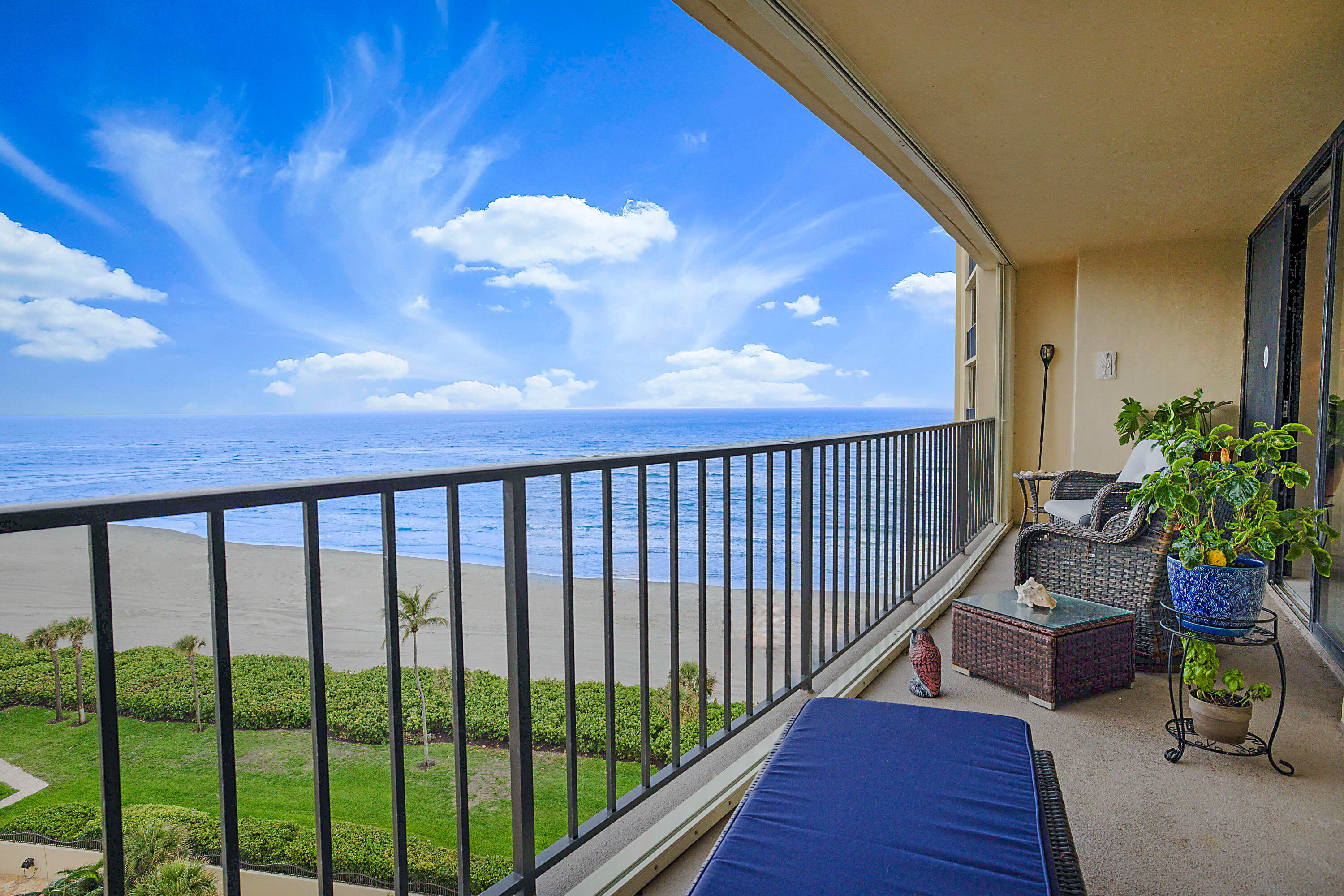 100 Ocean Trail Way, Unit 1003 Jupiter, FL 33477 - Photo 27 of 33 a balcony with wooden floor table and chairs