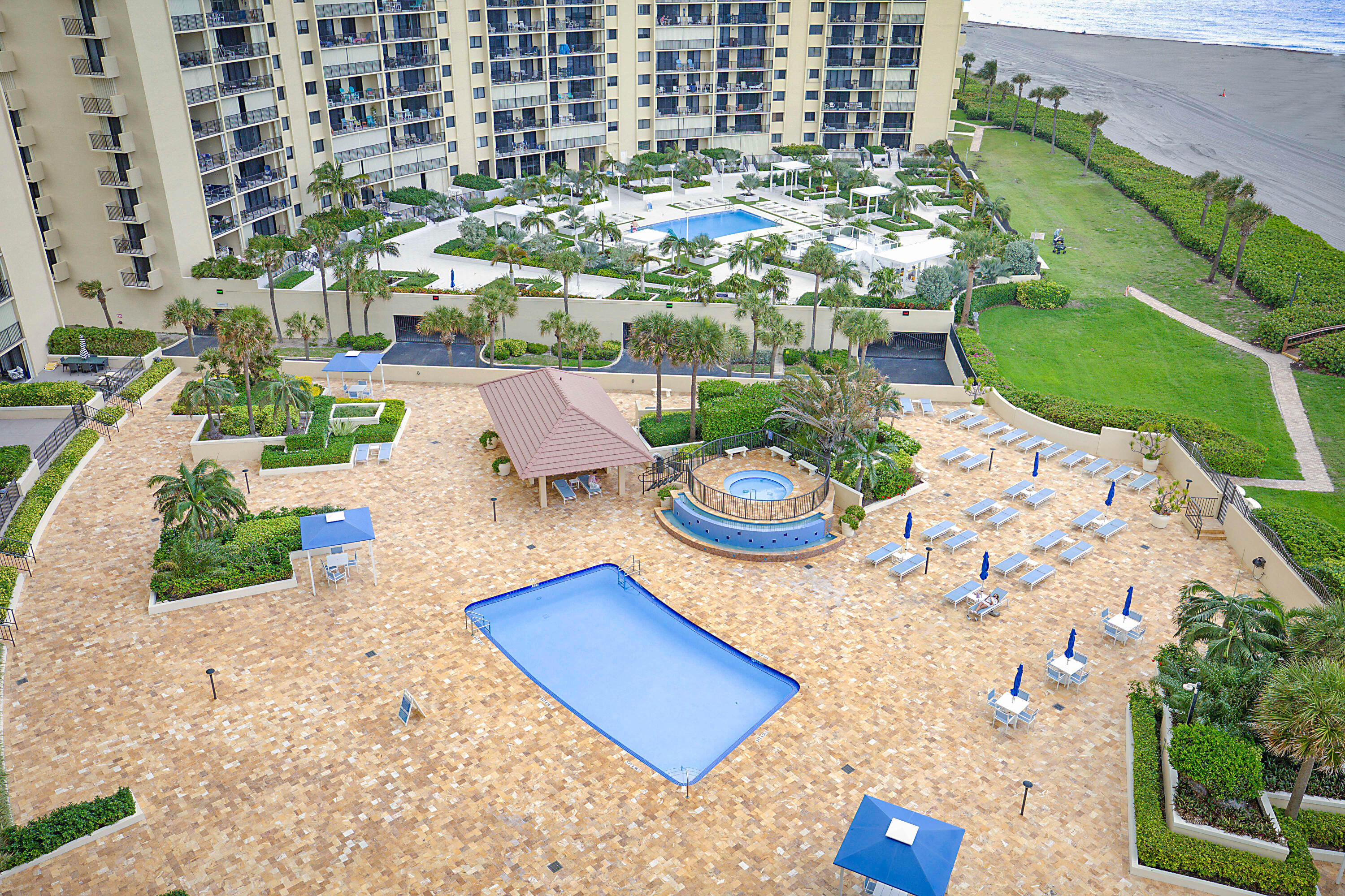 100 Ocean Trail Way, Unit 1003 Jupiter, FL 33477 - Photo 32 of 33 a view of a backyard with plants and outdoor seating