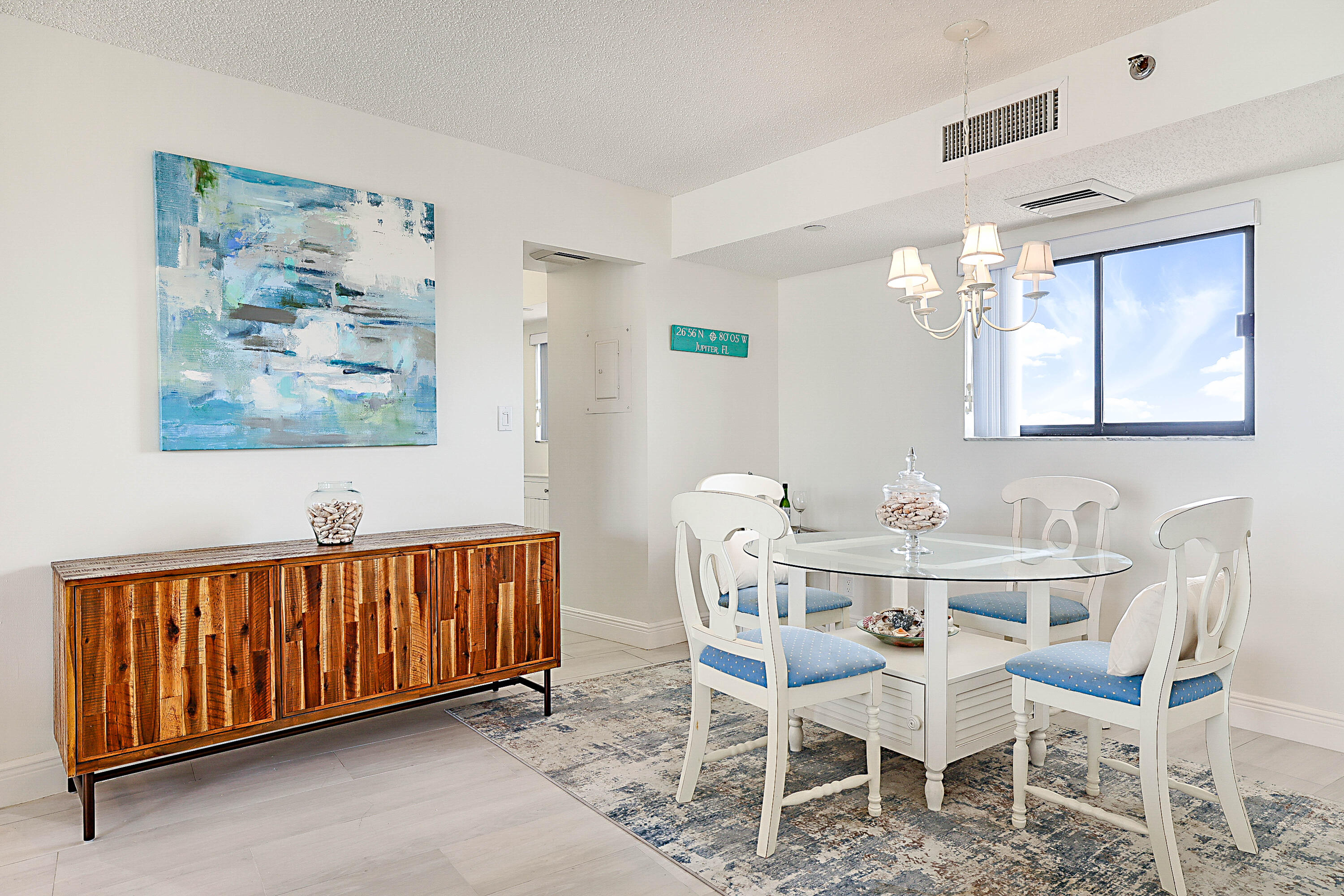 100 Ocean Trail Way, Unit 1003 Jupiter, FL 33477 - Photo 6 of 33 a view of a dining room with furniture and chandelier