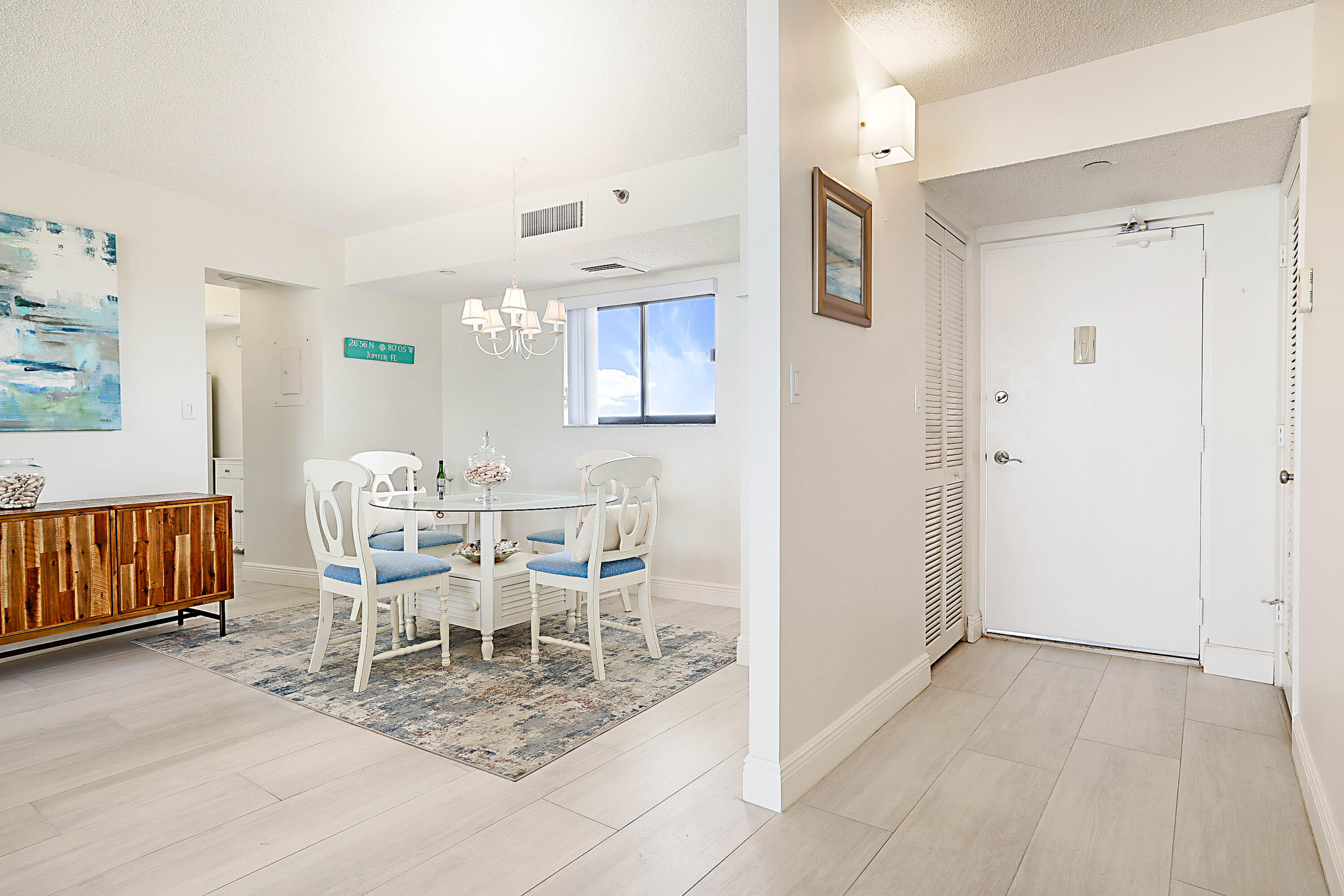 100 Ocean Trail Way, Unit 1003 Jupiter, FL 33477 - Photo 8 of 33 a dining room with furniture and wooden floor