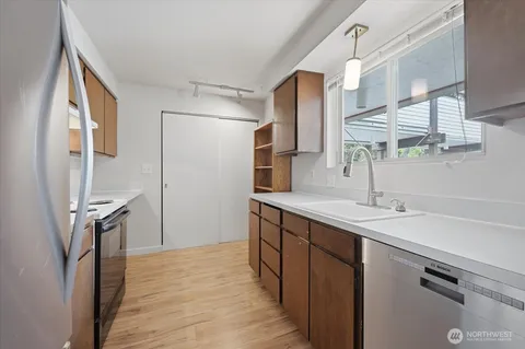 a kitchen with a sink appliances and cabinets