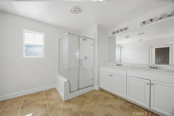 a spacious bathroom with a mirror sink and shower