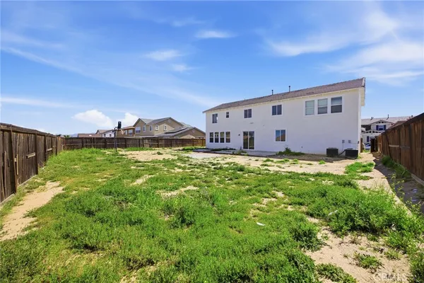 a view of a house with yard and sitting area