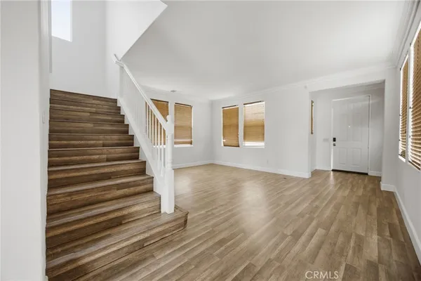 a view of an entryway with wooden floor and door