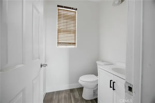 a white toilet sitting next to a bathroom sink