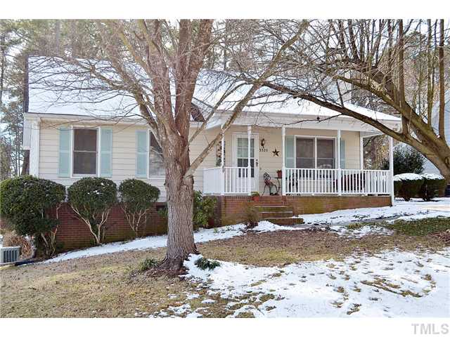 3325 Castlegate Drive Raleigh, NC 27616 - Photo 1 of 25 a front view of a house with a yard covered with trees