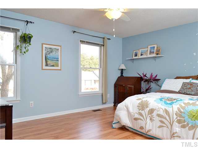 3325 Castlegate Drive Raleigh, NC 27616 - Photo 12 of 25 a bedroom with a bed and a chandelier