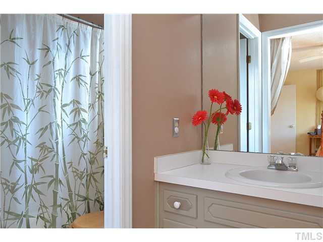 3325 Castlegate Drive Raleigh, NC 27616 - Photo 17 of 25 a bathroom with a sink and a mirror