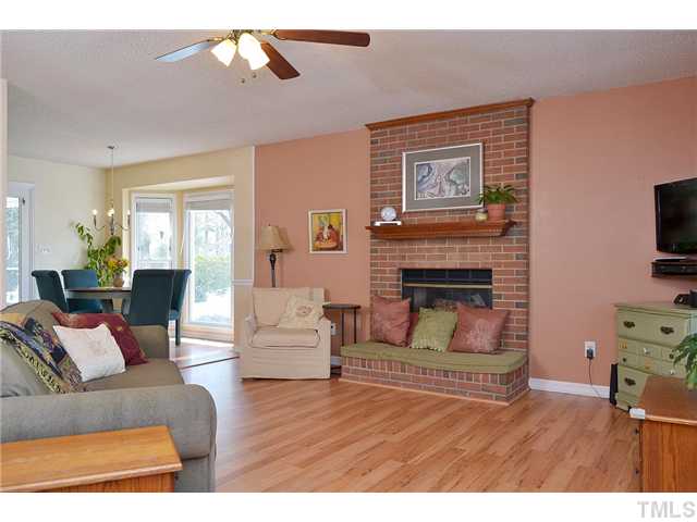 3325 Castlegate Drive Raleigh, NC 27616 - Photo 4 of 25 a living room with furniture a flat screen tv and a fireplace