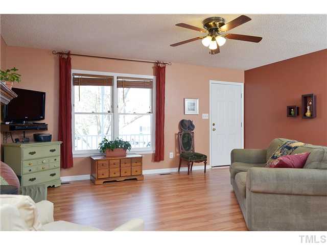 3325 Castlegate Drive Raleigh, NC 27616 - Photo 6 of 25 a living room with furniture and a flat screen tv