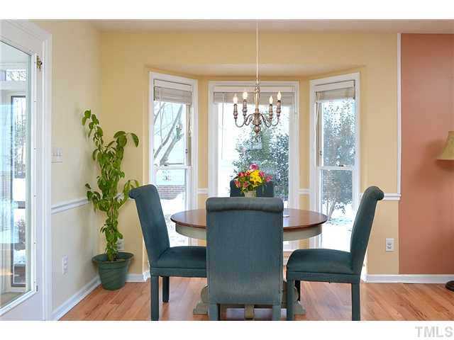 3325 Castlegate Drive Raleigh, NC 27616 - Photo 8 of 25 a dining room with furniture a potted plant and a potted plant