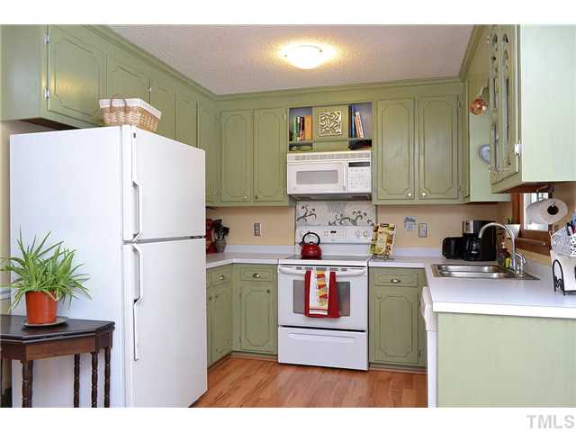3325 Castlegate Drive Raleigh, NC 27616 - Photo 9 of 25 a kitchen with a refrigerator a stove top oven a sink and dishwasher