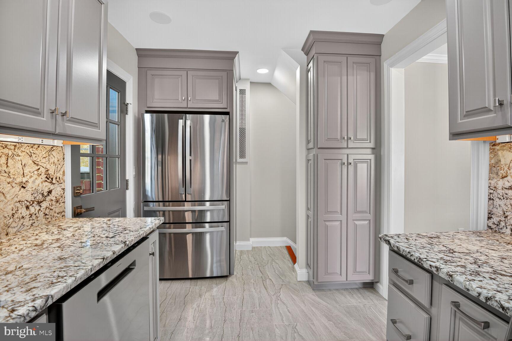 302 Penwood Road Silver Spring, MD 20901 - Photo 15 of 44 a kitchen with kitchen island granite countertop a refrigerator oven a sink and dishwasher