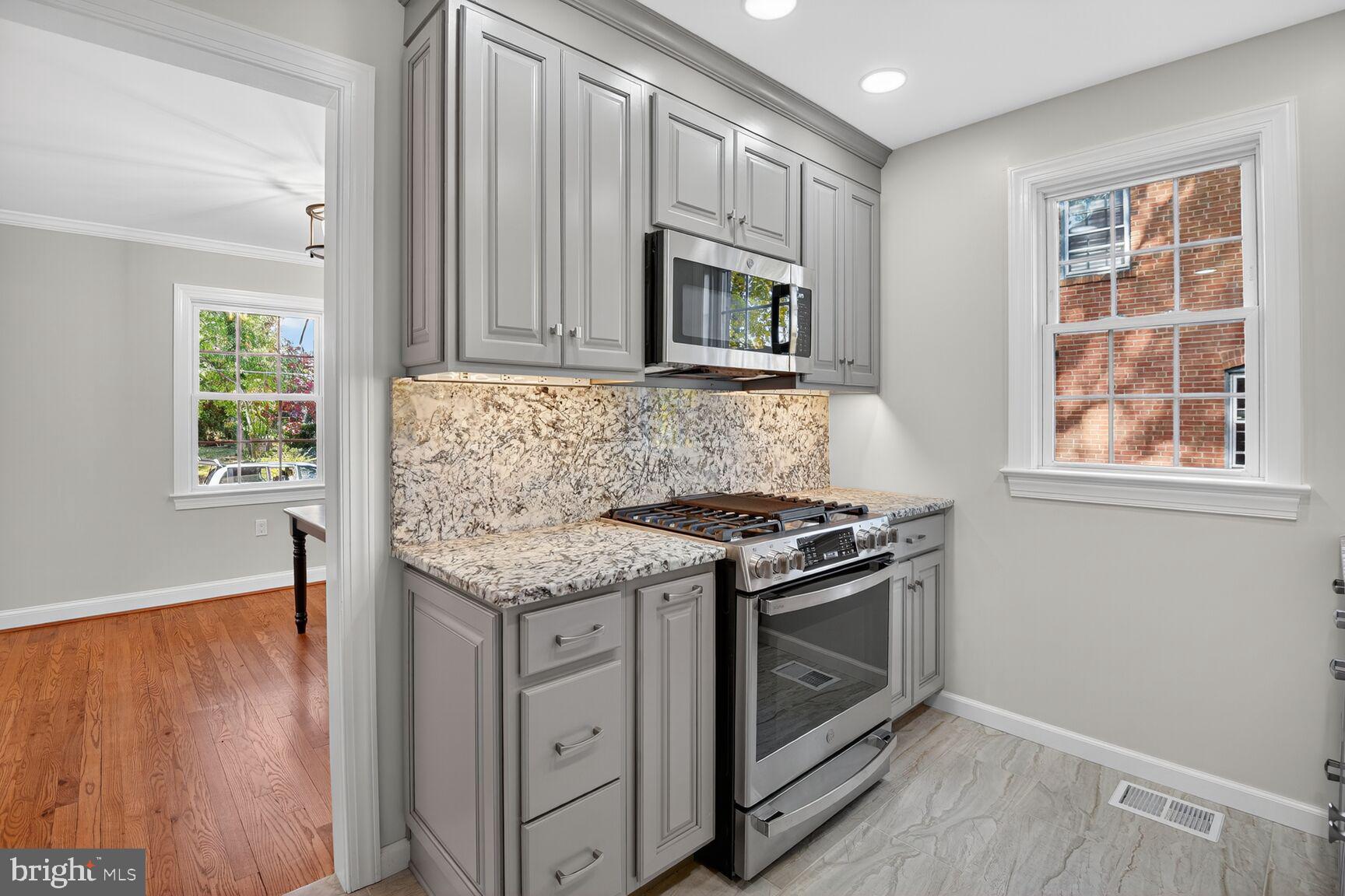 302 Penwood Road Silver Spring, MD 20901 - Photo 16 of 44 an empty room with windows and fireplace