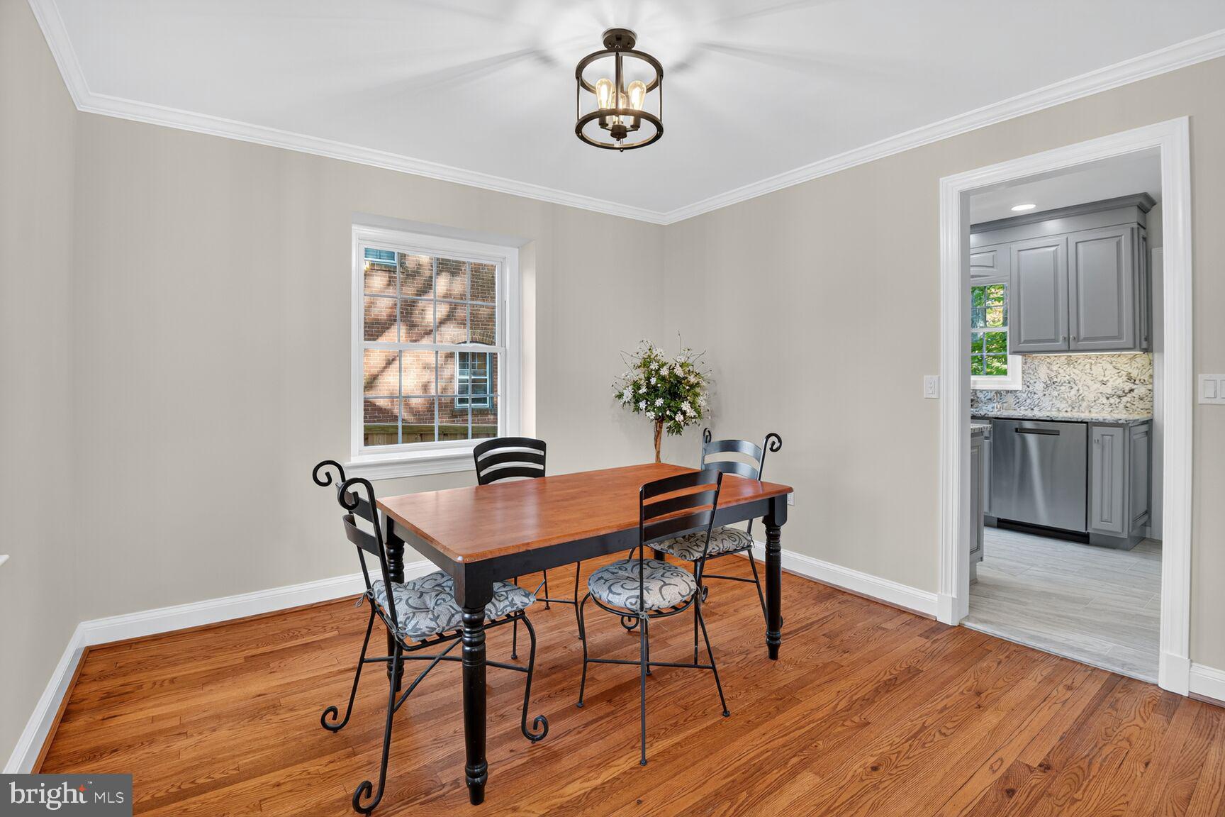 302 Penwood Road Silver Spring, MD 20901 - Photo 19 of 44 a view of a dining room with furniture and wooden floor