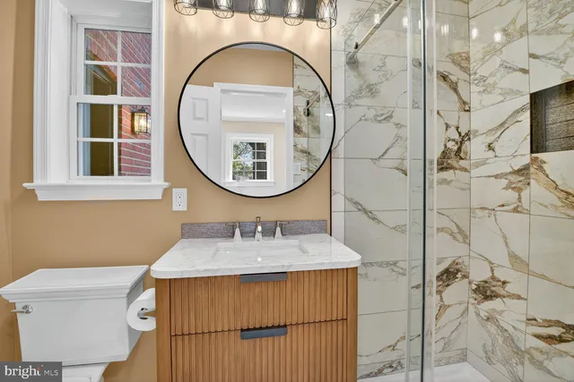 a bathroom with a sink a mirror and a toilet