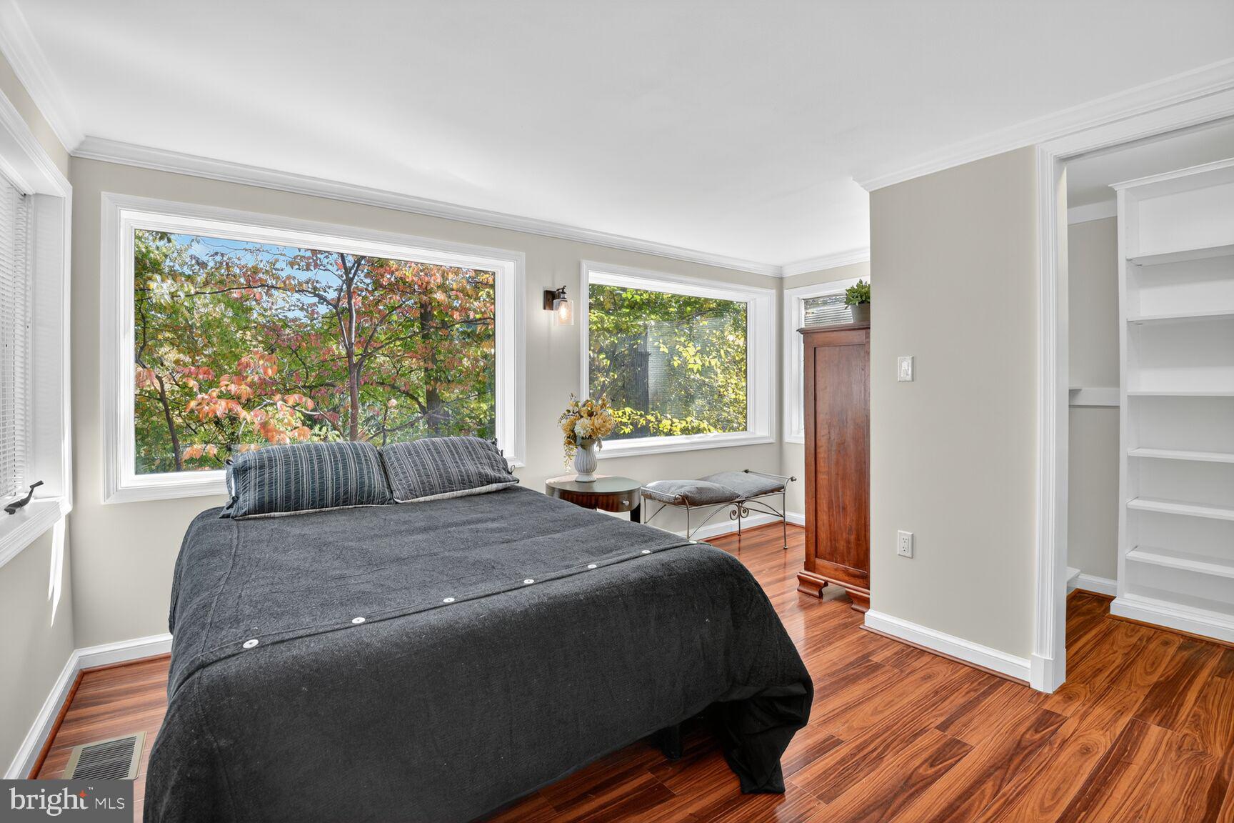 302 Penwood Road Silver Spring, MD 20901 - Photo 23 of 44 a bedroom with a bed and wooden floor