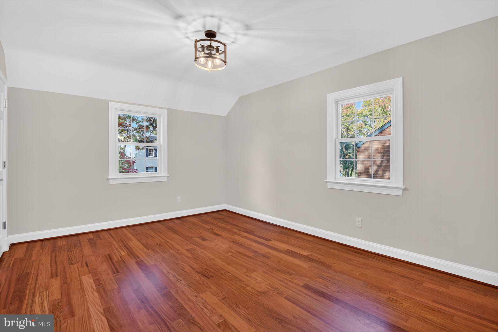 302 Penwood Road Silver Spring, MD 20901 - Photo 24 of 44 a view of a big room with wooden floor and windows