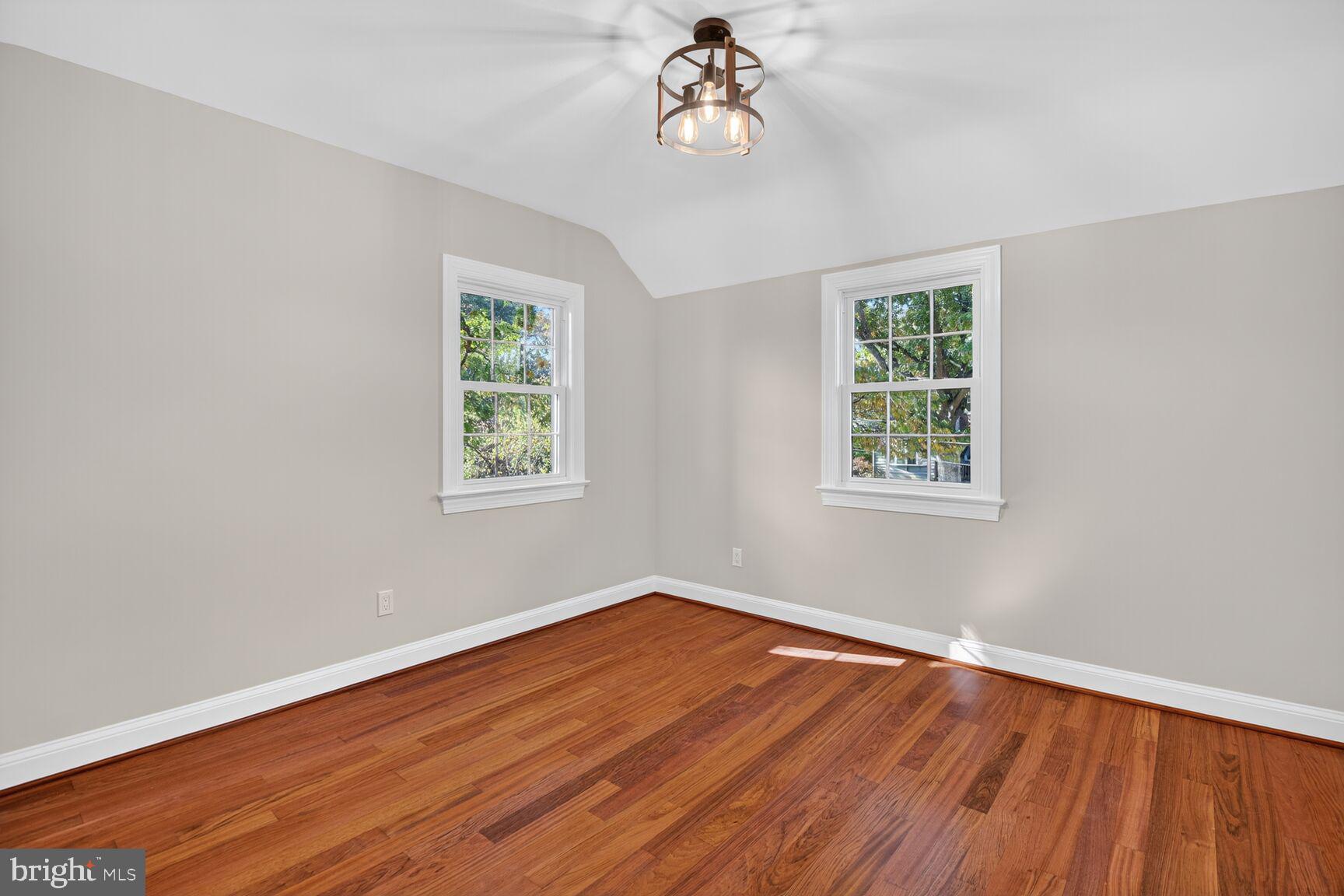 302 Penwood Road Silver Spring, MD 20901 - Photo 26 of 44 wooden floor in an empty room with a window