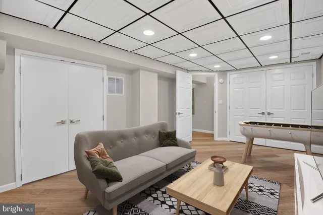 a living room with furniture a rug and white walls