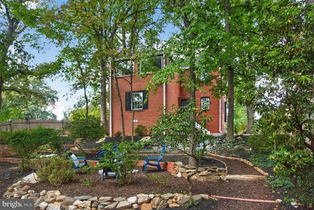 a couple of cars parked in front of a house