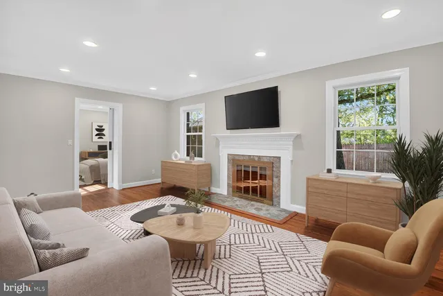 a living room with furniture a fireplace and a flat screen tv