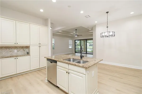 a kitchen with kitchen island white cabinets appliances and a counter