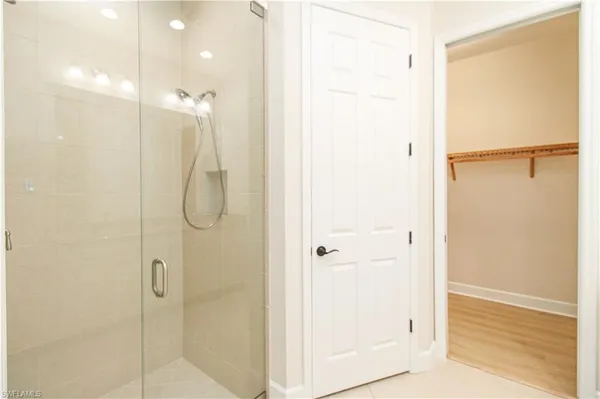 a bathroom with a shower and a glass door