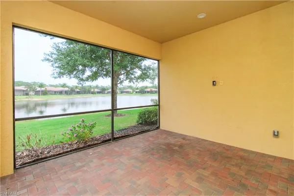 a view of a green field with wooden fence