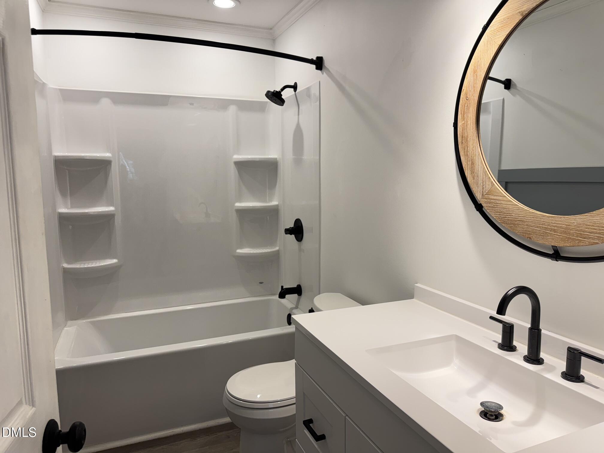 4632 Culbreth Road Oxford, NC 27565 - Photo 16 of 20 a bathroom with a sink a toilet and a mirror