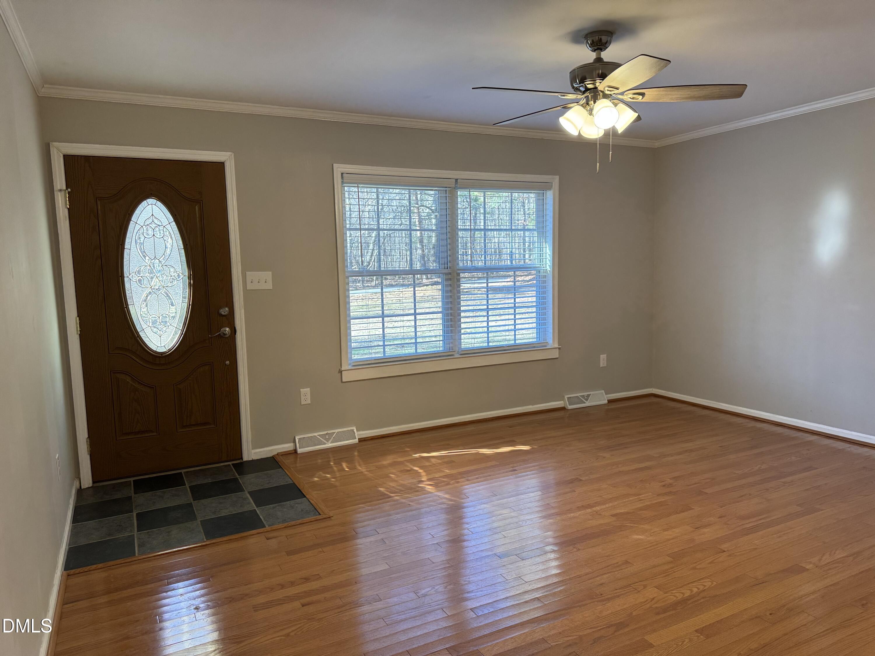 4632 Culbreth Road Oxford, NC 27565 - Photo 4 of 20 an empty room with wooden floor mirror and windows
