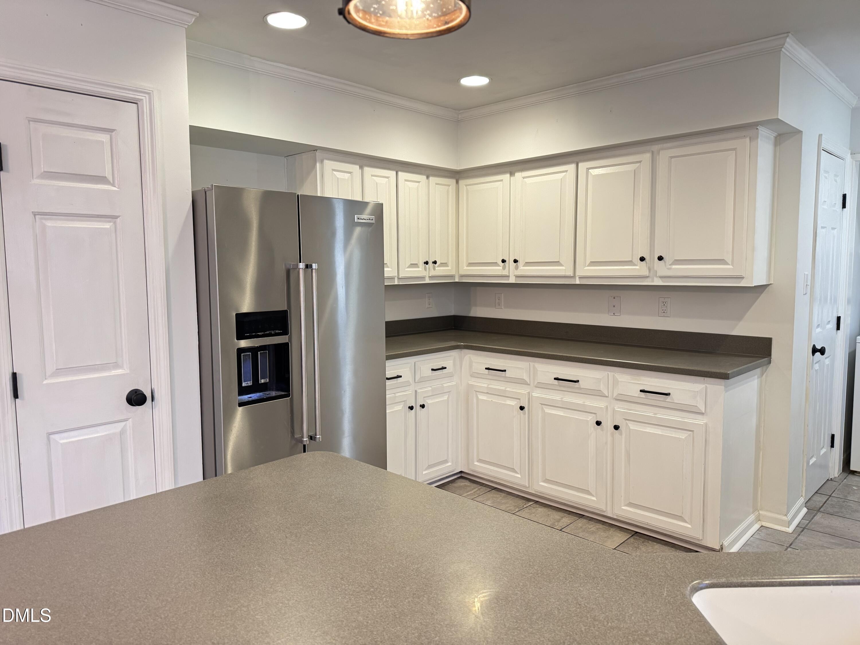 4632 Culbreth Road Oxford, NC 27565 - Photo 7 of 20 a kitchen with white cabinets and refrigerator