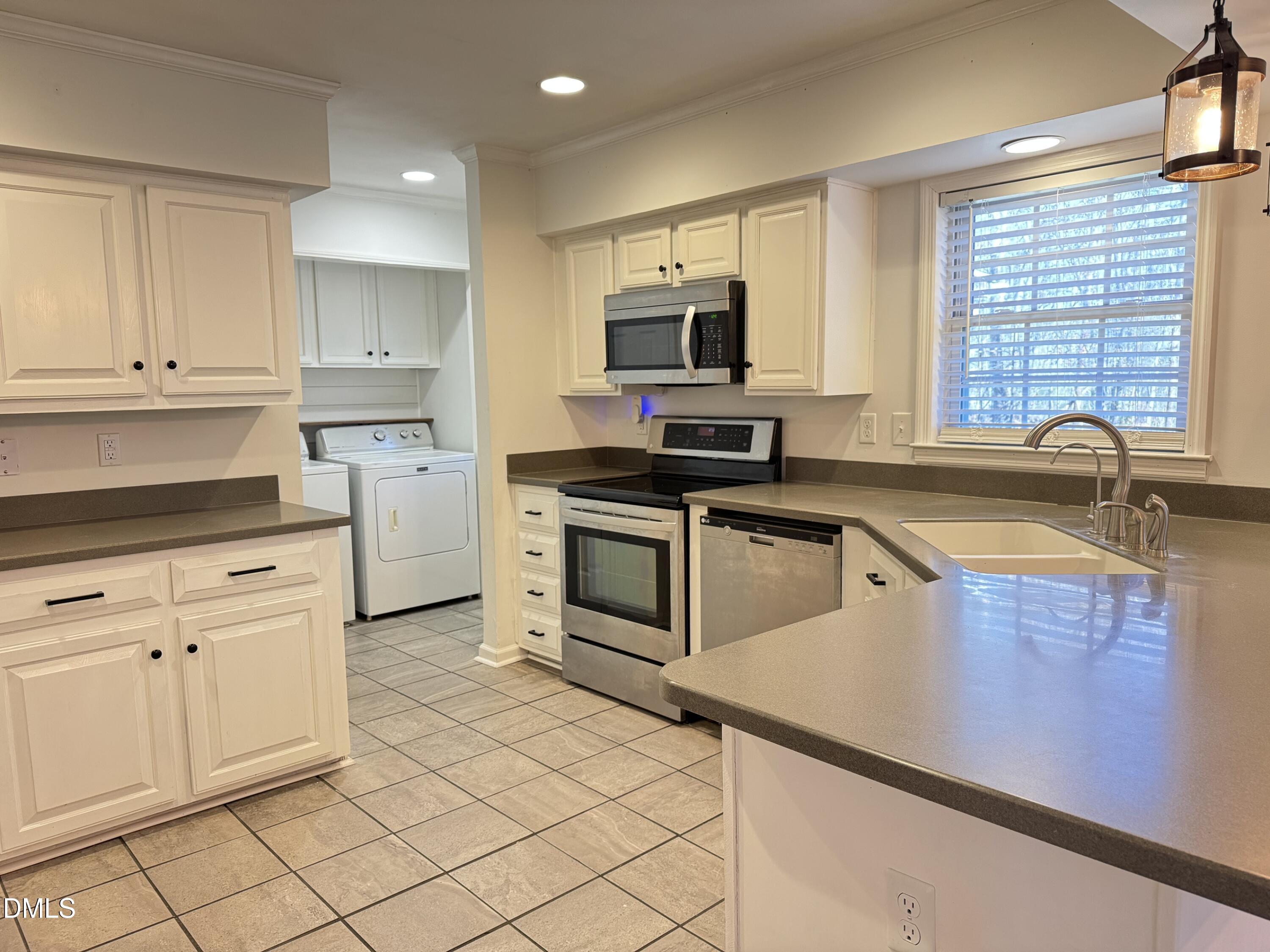 4632 Culbreth Road Oxford, NC 27565 - Photo 8 of 20 a kitchen with granite countertop a sink stainless steel appliances and cabinets