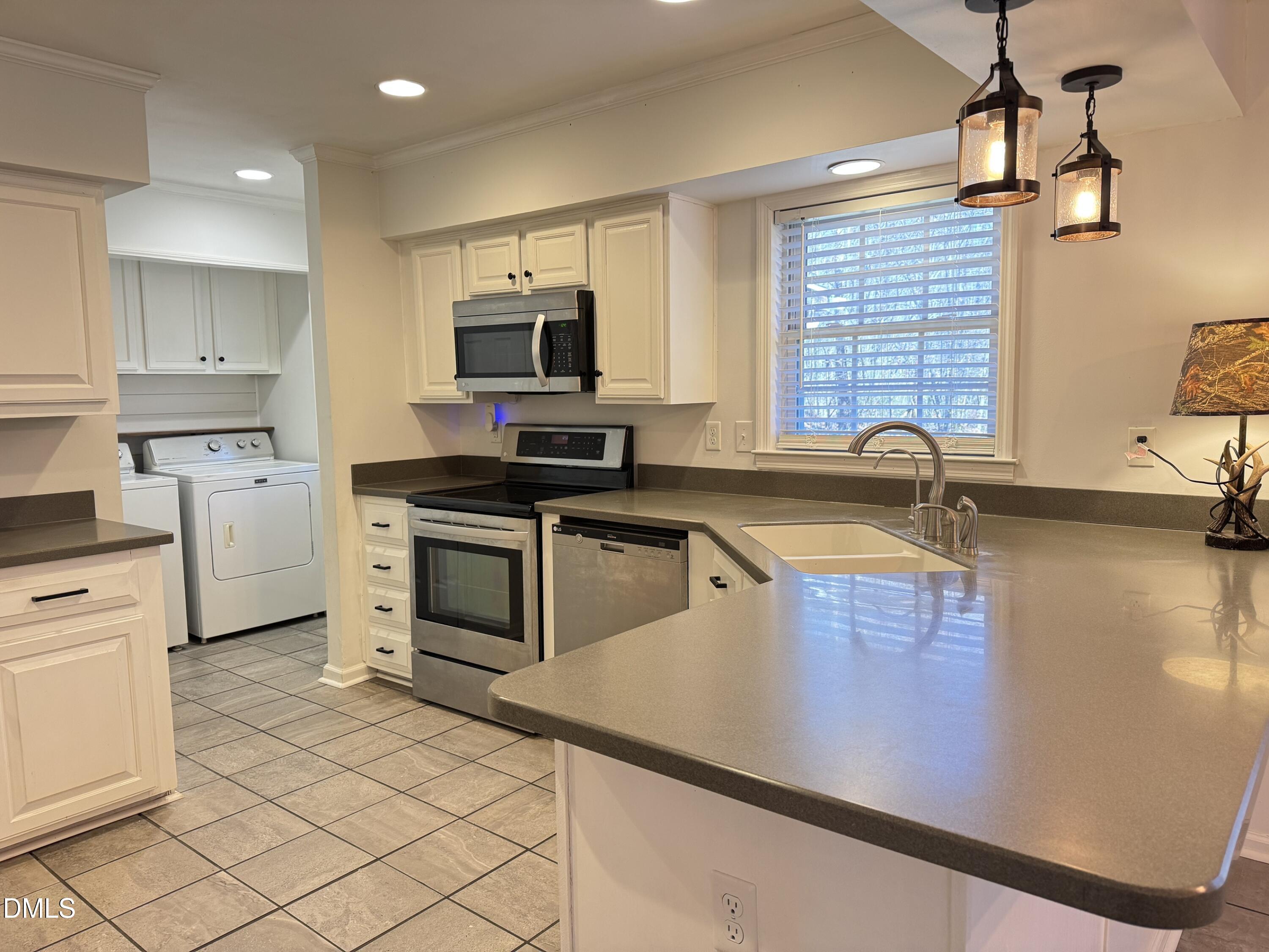 4632 Culbreth Road Oxford, NC 27565 - Photo 9 of 20 a kitchen with a sink appliances and cabinets