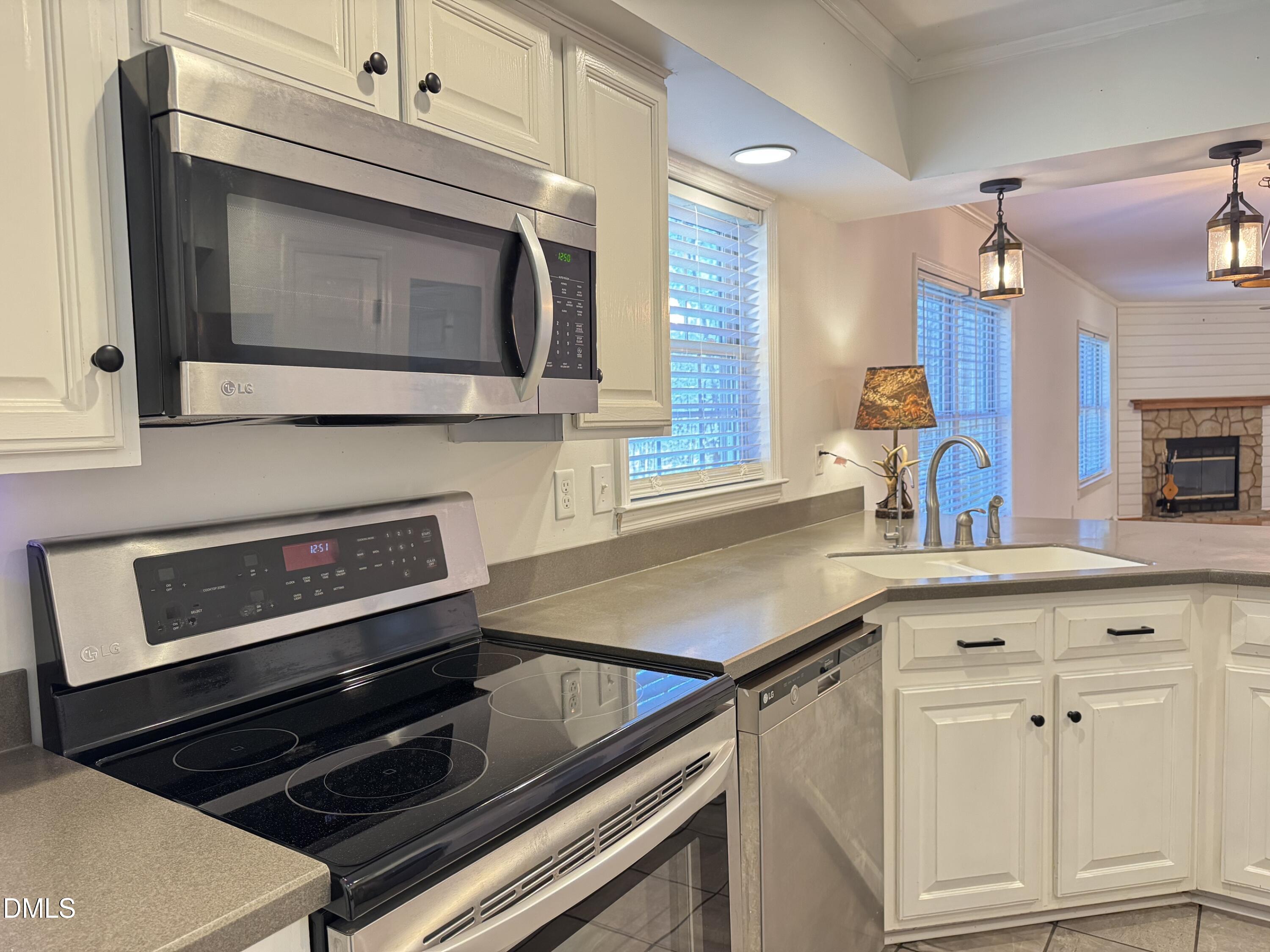 4632 Culbreth Road Oxford, NC 27565 - Photo 10 of 20 a kitchen with a stove microwave and sink